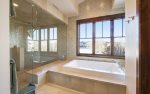 En suite master bathroom with Jacuzzi tub and steam shower.